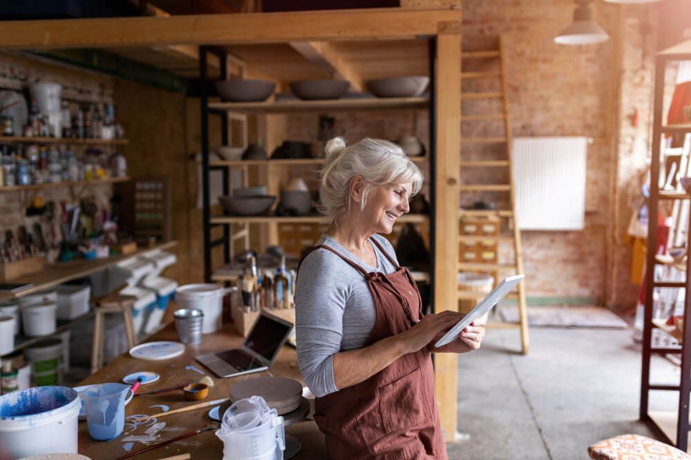 A woman standing in an art studio in an old barn