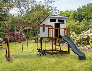 wooden swing set with a white enclosed playhouse and a green slide