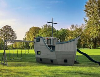 gray pirate ship playset in a grassy field at sunset